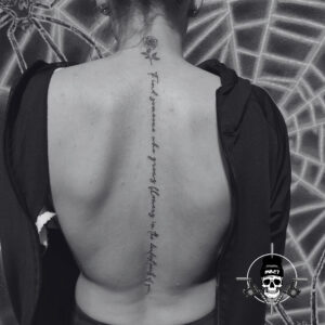 random text on back tattoo